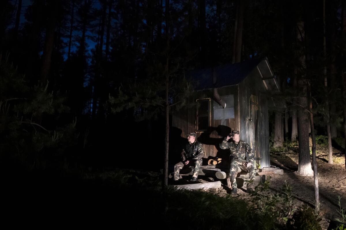 Members of the Lithuania State Border Guard Service patrol on the border with Belarus, near the small town Kapciamiestis, some 160km (100 miles) of the capital Vilnius, Lithuania, Thursday, June 10, 2021. Lithuania has detained nine Iraqi asylum-seekers who had entered the Baltic country from Belarus, officials said Monday, pointing a finger at Belarus for allegedly being involved in sending repeated groups of immigrants into Lithuania. (AP Photo/Mindaugas Kulbis)