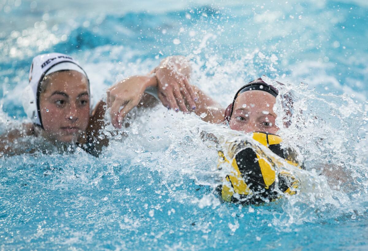 Newport Harbor's Sofia Del Villar and Laguna Beach's Ava Knepper battle for a ball during a Surf League match.