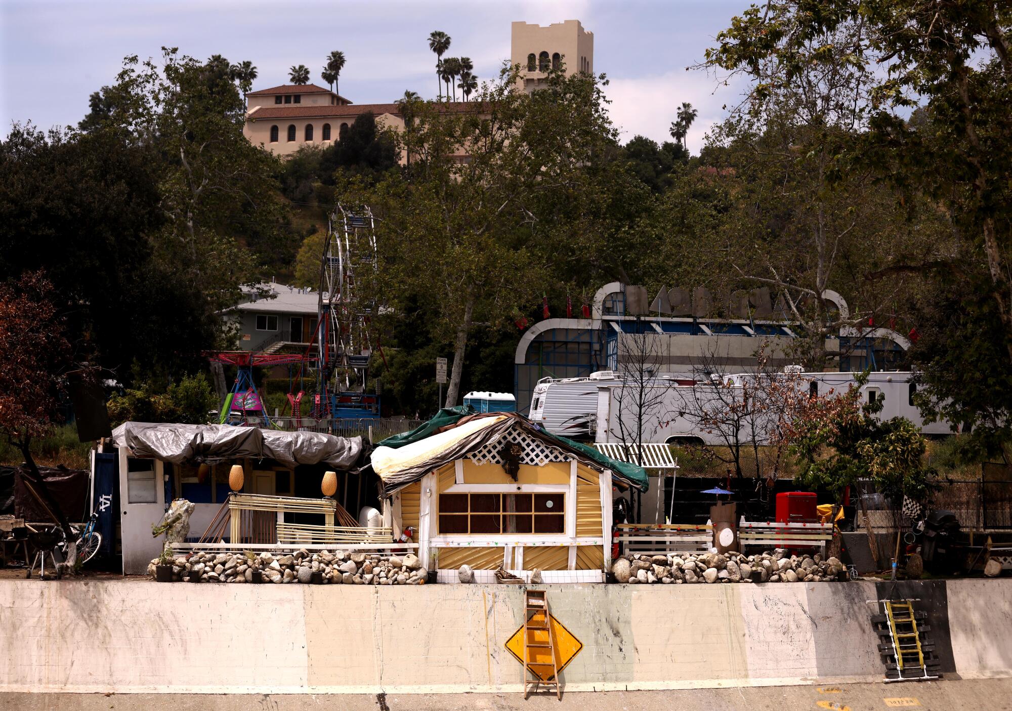 The Southwest Museum sits on a hill above the makeshift home of Alejandro Diaz above the 110 Freeway in Highland Park.