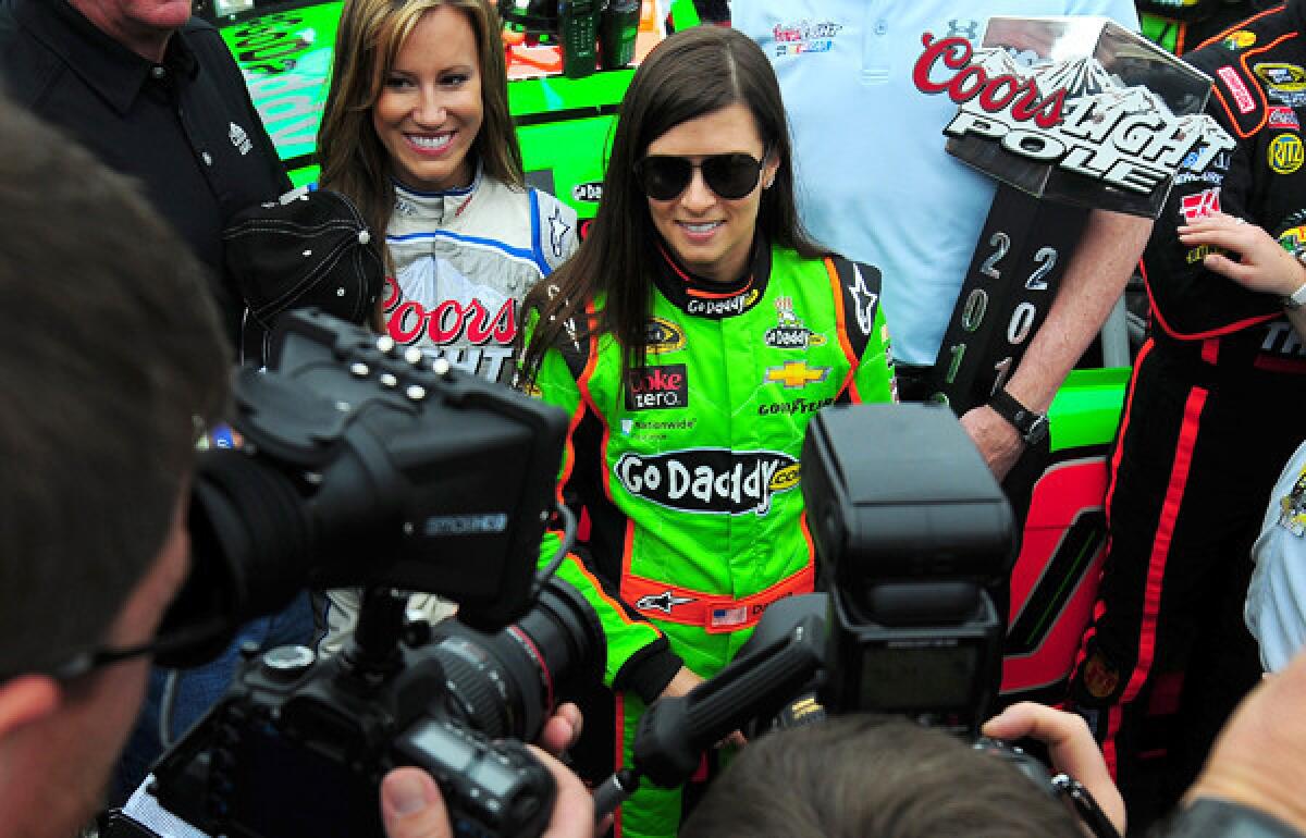 Danica Patrick is engulfed in media as she stands near her car before the start of the Daytona 500 on Sunday.