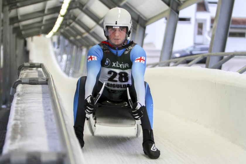 FILE - Saba Kumaritashvili of Georgia poses for a photo before speeding down the track during a men's race at the 52th FIL Luge European Championships in Sigulda, Latvia, Thursday, Jan. 7, 2021. Saba Kumaritashvili will compete in luge next month at the Beijing Olympics, 12 years after his cousin Nodar Kumaritashvili died in a training accident at the Vancouver Games. (AP Photo/Sandra Skutane, File)