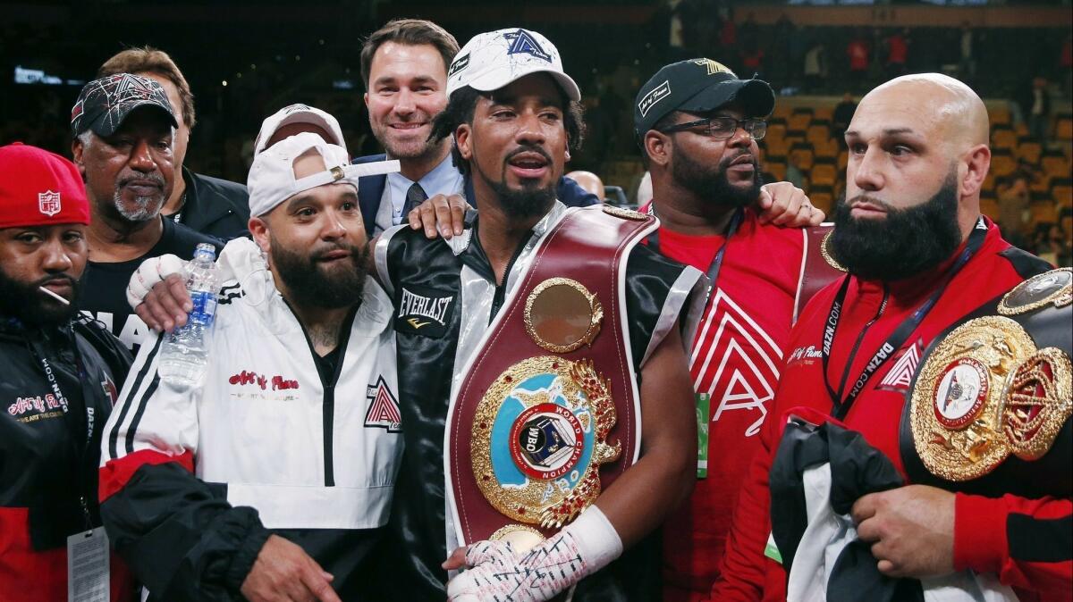 Demetrius Andrade, center, stands with members of his team after defeating Walter Kautondokwa in a WBO middleweight championship boxing match in October.