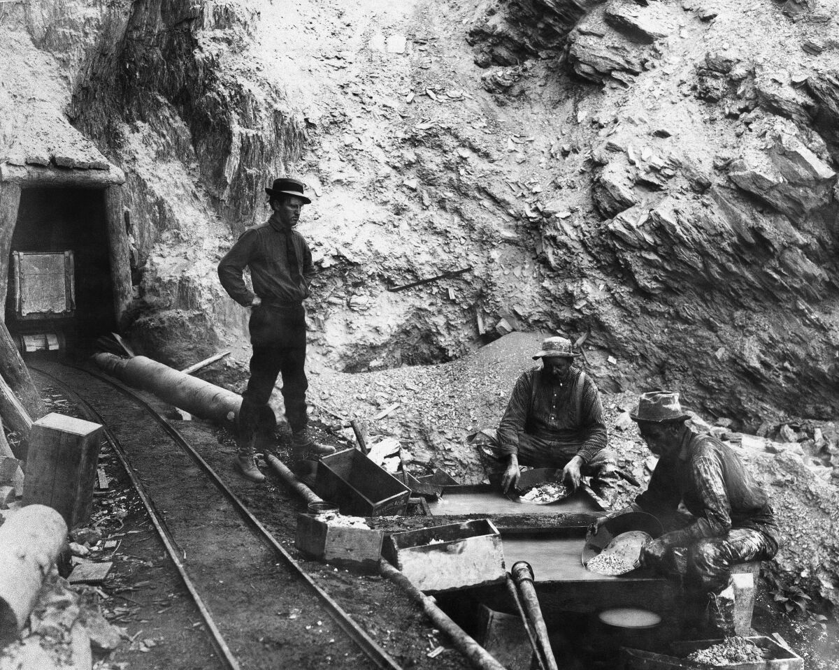 Black and white photo of men in a mine 