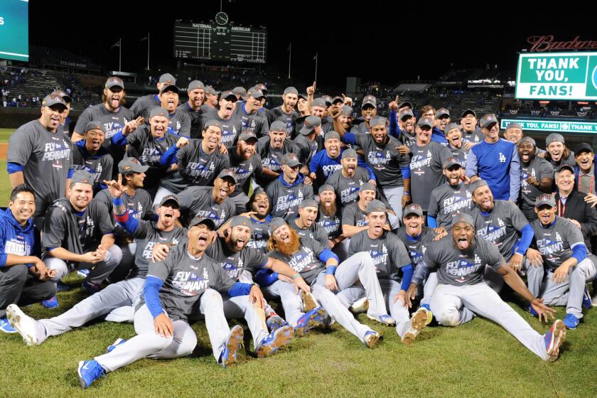 Dodgers players celebrate the National League pennant after defeating the Cubs.