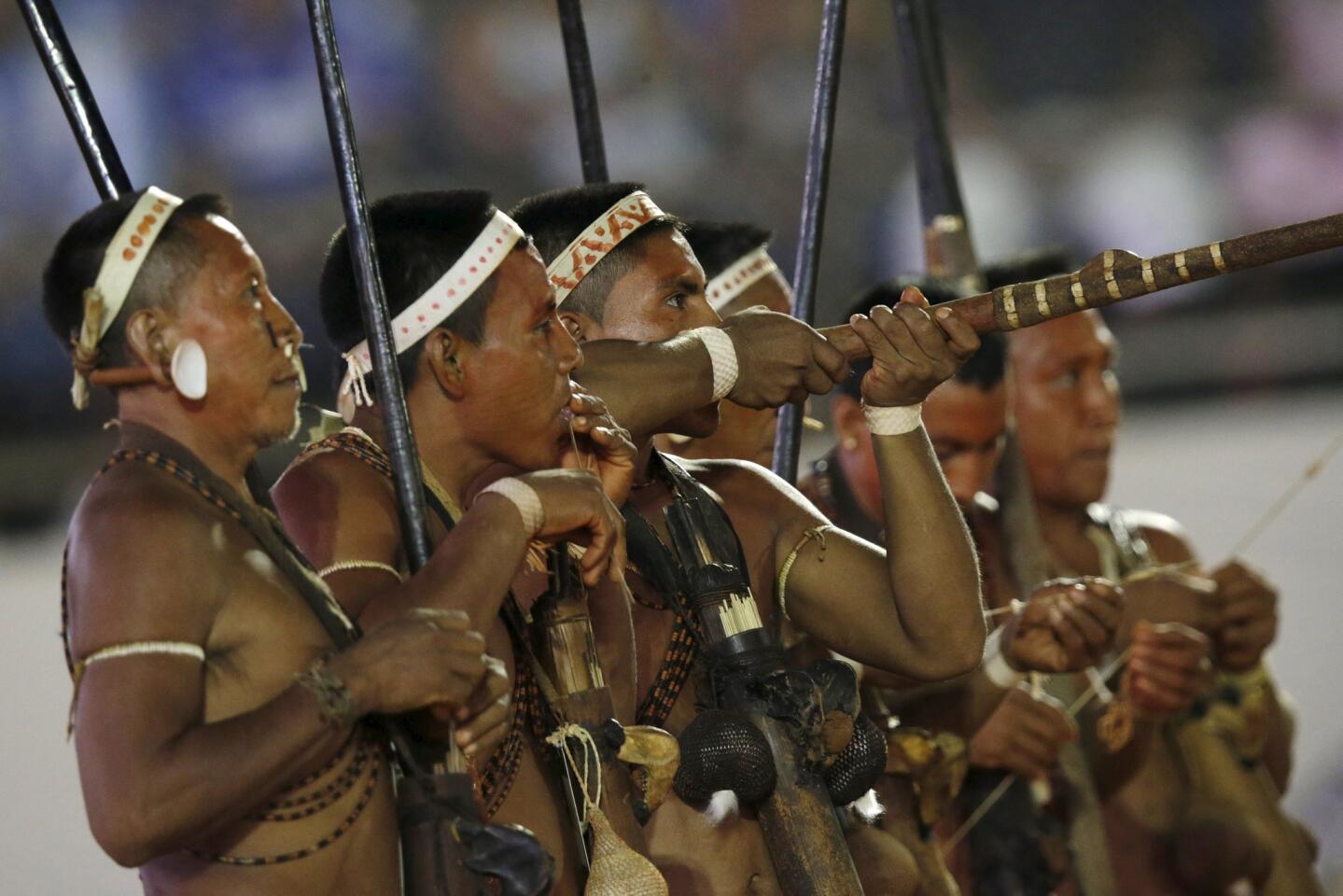 An indigenous man from the Matis tribe demonstrates the use of a blowpipe during the first World Games for Indigenous Peoples in Palmas