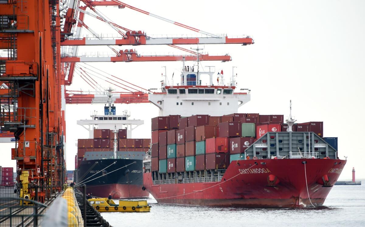 A freighter berths at a container pier in Tokyo. Japan, Malaysia and South Korea have all been identified as strategically depressing the value of their currency.