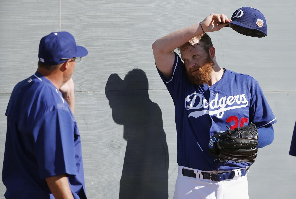 The Dodgers' Brett Anderson, right, talks with special advisor Greg Maddux during spring training on Wednesday.