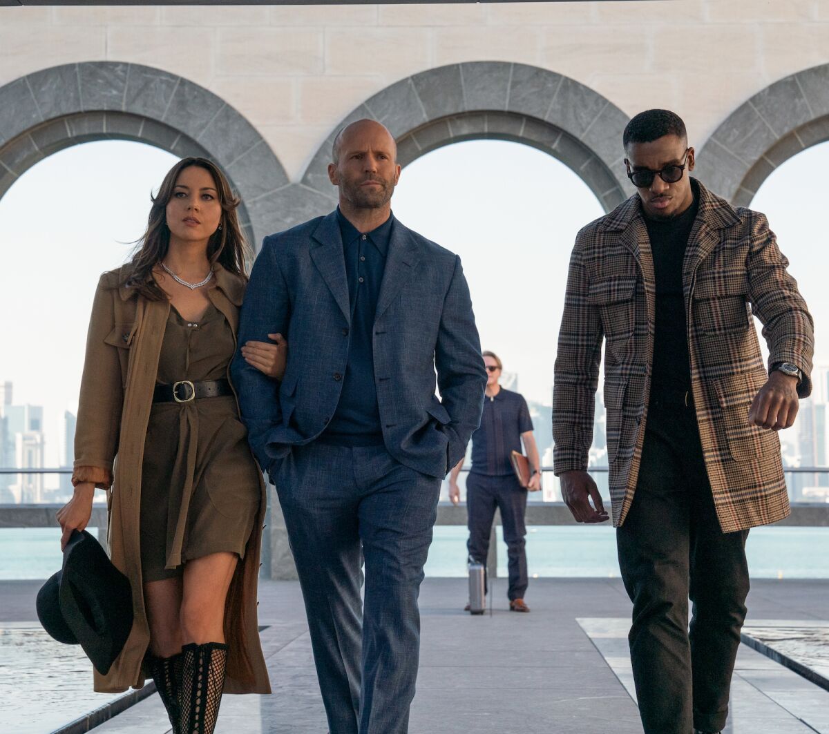 Aubrey Plaza, from left, Jason Statham and Bugzy Malone in the movie "Operation Fortune: Ruse de guerre."