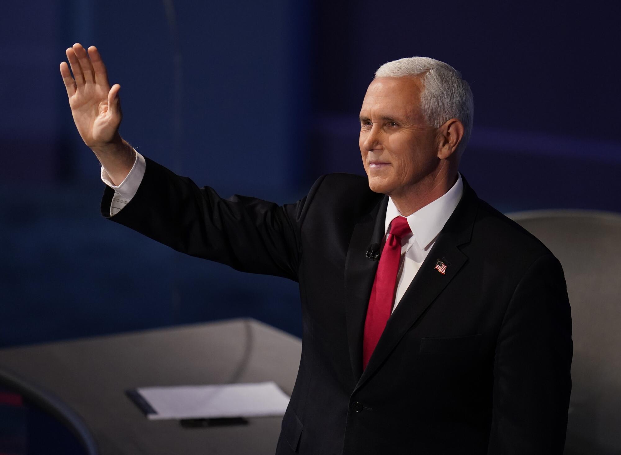 Vice President Mike Pence waves to the debate audience