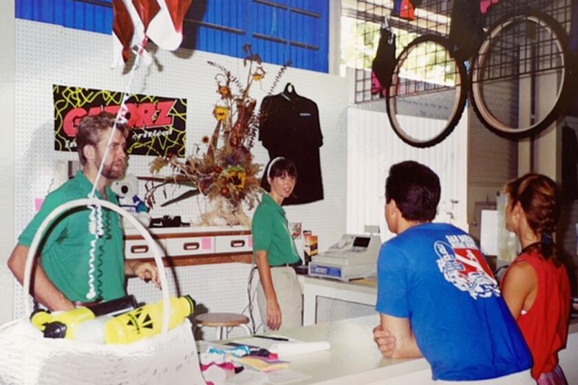 Mike and Debbe Simmons working the counter on July 4, 1992, opening day of their Mountain Bike Warehouse in Pacific Beach.