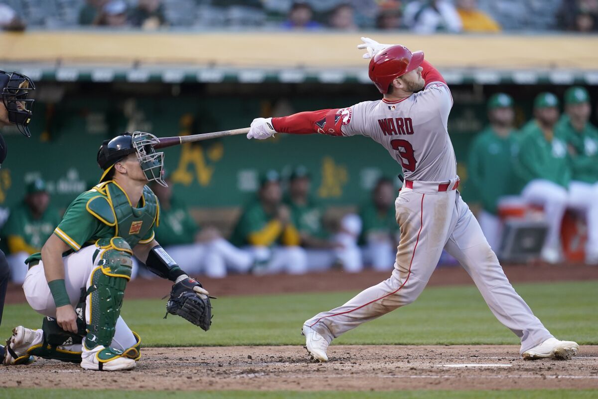 The Angels' Taylor Ward watches his grand slam in front of Athletics catcher Sean Murphy on May 14, 2022. 