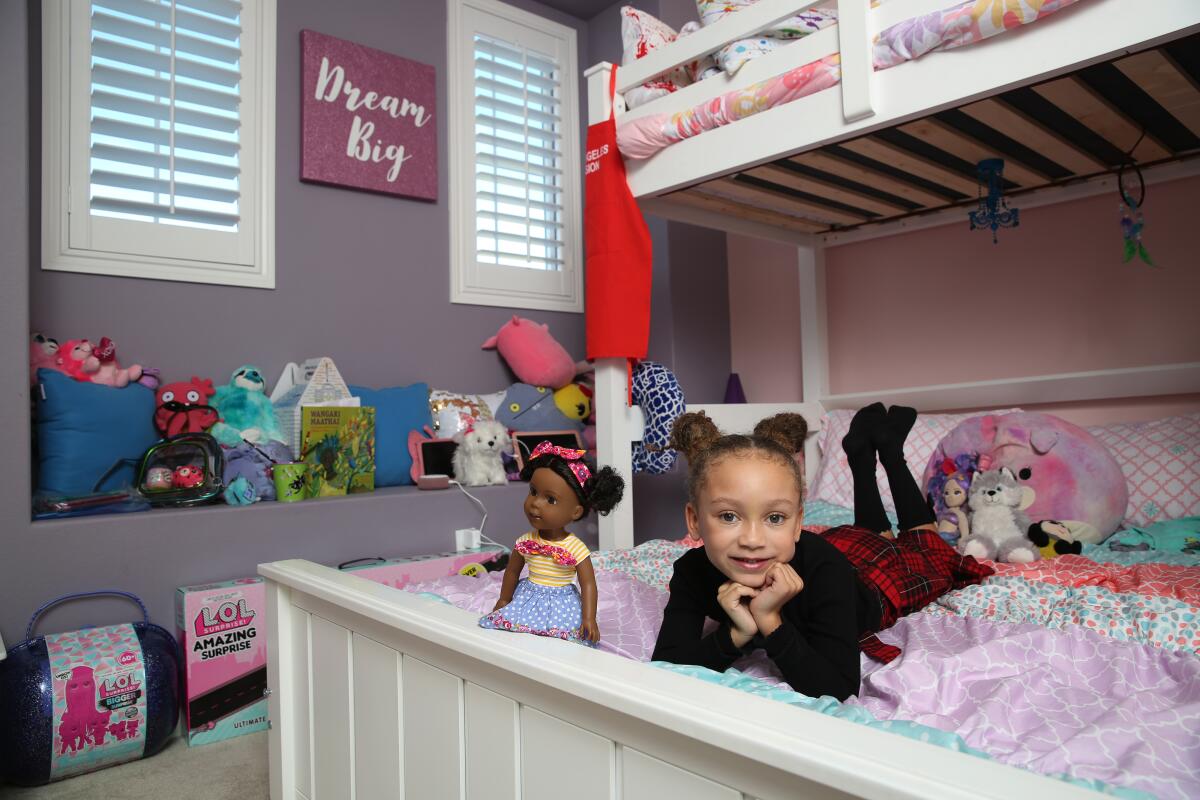Mykal-Michelle Harris, 7, has outfitted her purple-and-pink bedroom with plenty of dolls and stuffed animals.