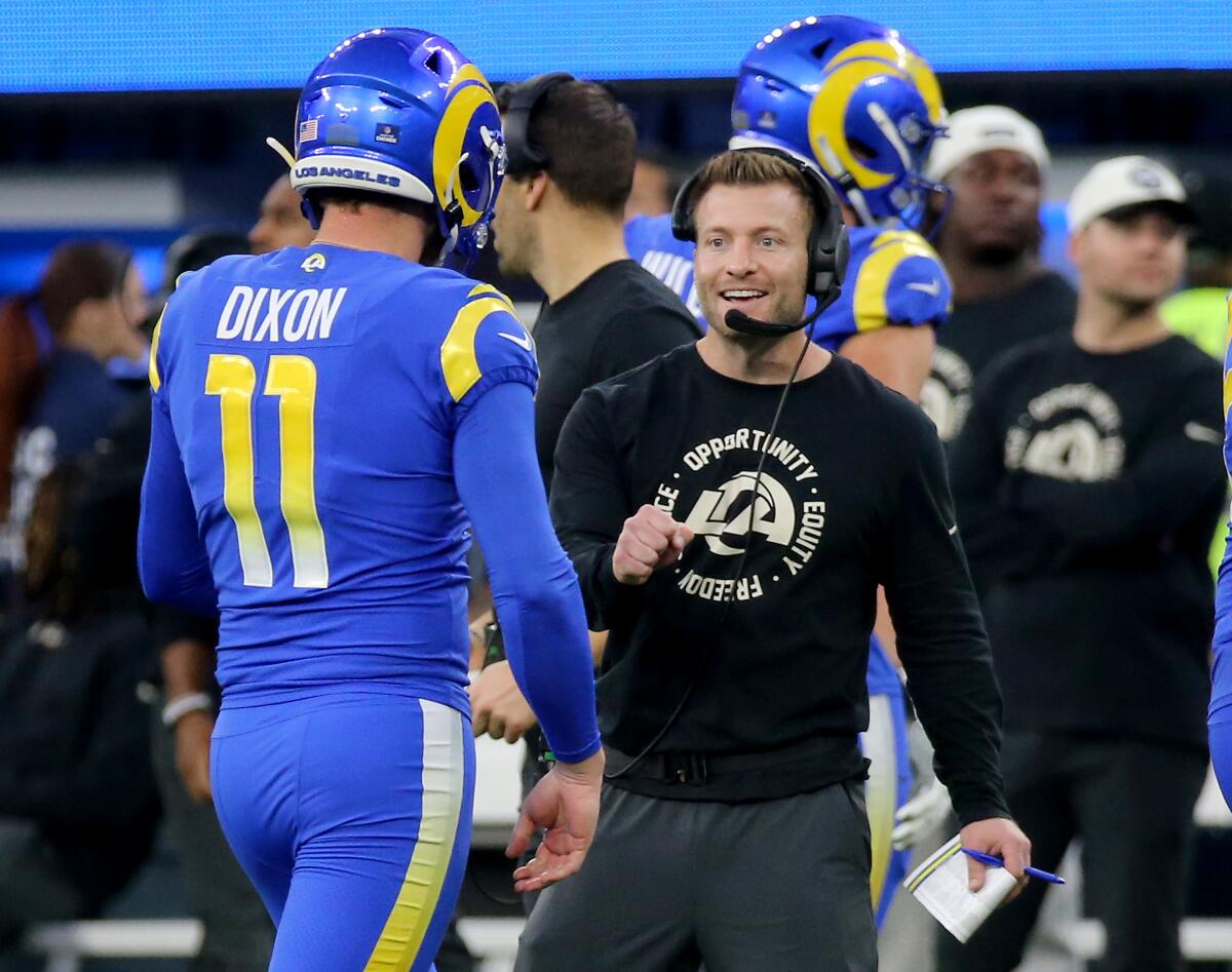  Rams head coach Sean McVay flashes a smile to Riley Dixon (11), who did not have to punt against Denver.