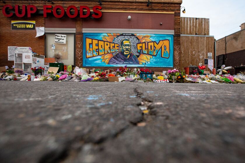 MINNEAPOLIS , MINNESOTA - MAY 31: The mural and makeshift memorial outside Cup Foods where George Floyd was murdered by a Minneapolis police officer on Sunday, May 31, 2020 in Minneapolis , Minnesota. (Jason Armond / Los Angeles Times)