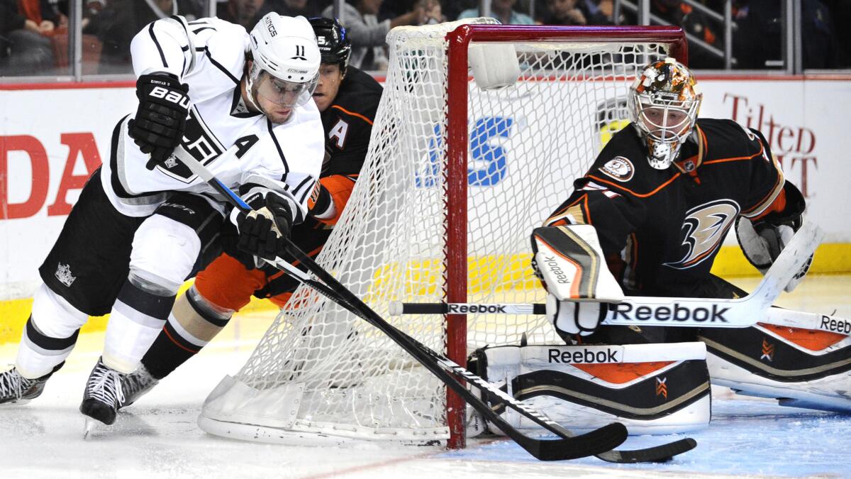 Kings forward Anze Kopitar, left, tries to score on a wraparound attempt past Ducks goalie Frederik Andersen during the first period of the Kings' 6-5 shootout loss Wednesday at Honda Center.
