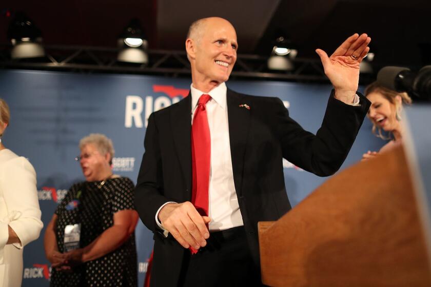 NAPLES, FLORIDA - NOVEMBER 06: Florida Governor Rick Scott and his wife, Ann Scott, (L) take to the stage during his election night party at the LaPlaya Beach & Golf Resort on November 06, 2018 in Naples, Florida. Governor Scott defeated Sen. Bill Nelson for the Florida Senate seat. (Photo by Joe Raedle/Getty Images) ** OUTS - ELSENT, FPG, CM - OUTS * NM, PH, VA if sourced by CT, LA or MoD **