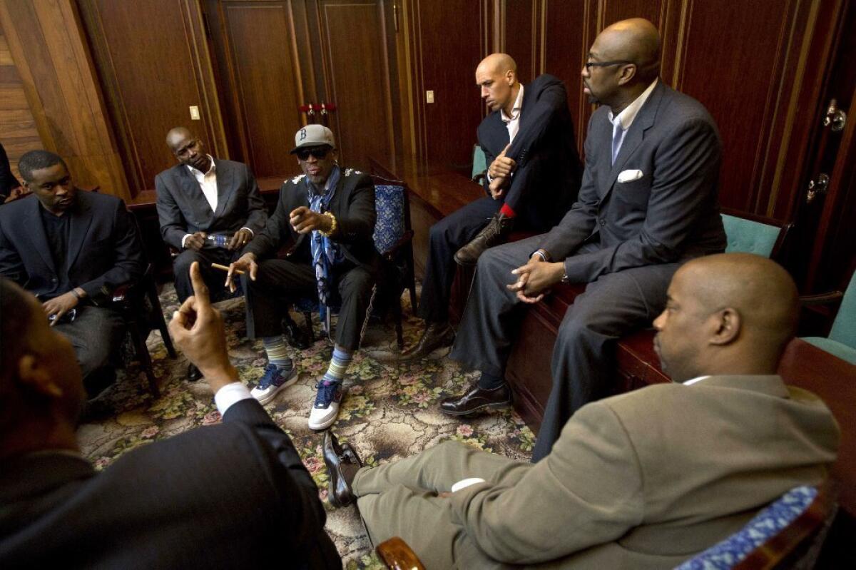 Dennis Rodman, center left, speaks with fellow U.S. basketball players during a team meeting at a Pyongyang, North Korea, hotel Tuesday in advance of Wednesday's game against a North Korean team.
