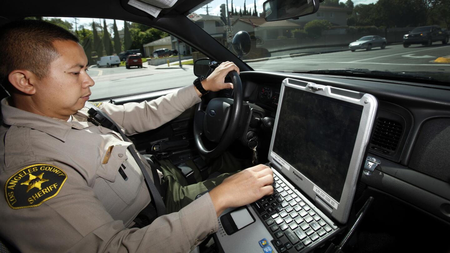 Deputy Charlie Cam of the Los Angeles County Sheriff's Department has the only patrol car at the La Mirada substation that is equipped with ASAP, a four camera roof-mounted system that constantly scans for and photographs the license plates of nearby cars.