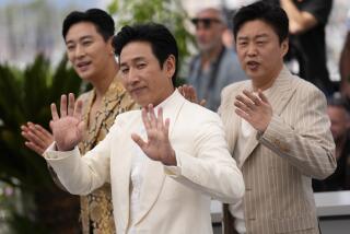 Ju Ji-hoon, from left, Lee Sun-kyun and Kim Hee-won pose for photographers at the photo call for the film 'Project Silence' at the 76th international film festival, Cannes, southern France, Monday, May 22, 2023. (Photo by Scott Garfitt/Invision/AP)