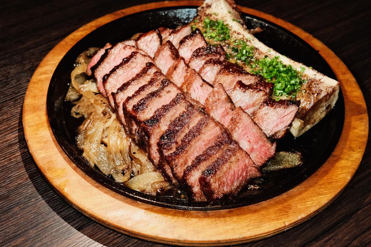 Sliced zabuton steak with bone marrow on a skillet at Danbi restaurant in Koreatown.