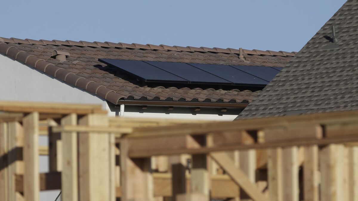 Solar panels are seen on the rooftop on a home in a new development.