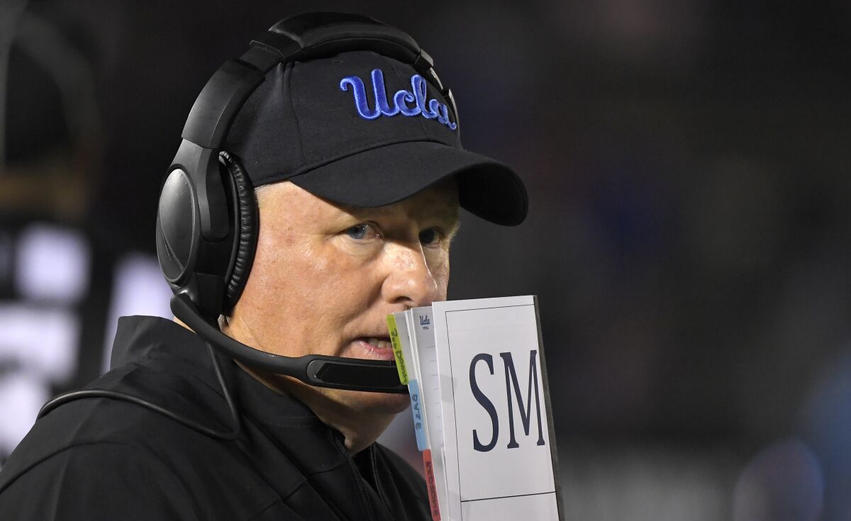 UCLA coach Chip Kelly stands on the sideline at the Rose Bowl.