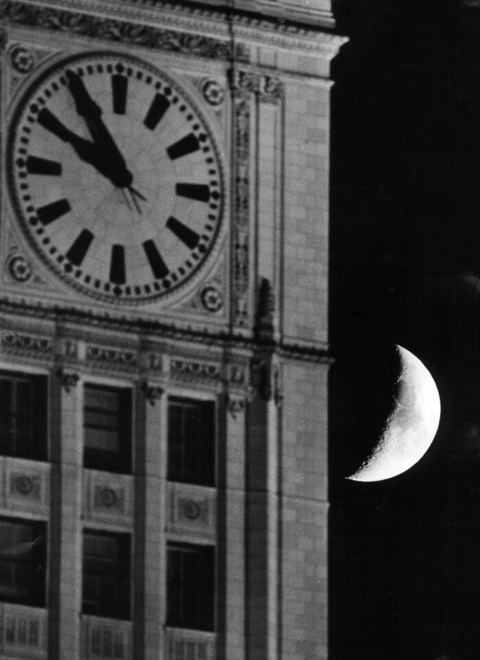 The moon hangs in the sky above Chicago as the clock on the Wrigley Building indicates 9:56 p.m., the time when Apollo 11 astronaut Neil Armstrong set foot on lunar soil July 20, 1969.
