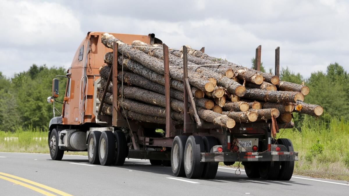 The rise and fall of wood-product factory workers tracks closely to the U.S. housing bubble and subsequent mortgage crisis. Above, a truck hauls logs to a lumber mill.