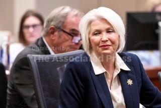 FILE - Former Mesa County Clerk and Recorder Tina Peters smiles at supporters sitting behind her during her sentencing for her election interference case at the Mesa County District Court, Thursday, Oct. 3, 2024, in Grand Junction, Colo. (Larry Robinson/The Grand Junction Daily Sentinel via AP, File)