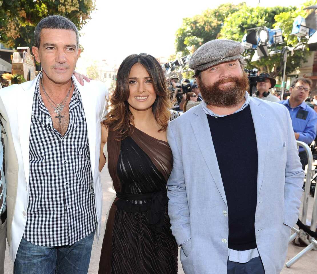 Actor Antonio Banderas, left, actress Salma Hayek and actor Zach Galifianakis arrive at the premiere of Dreamworks Animation's "Puss In Boots" at the Regency Westwood Theatre in Los Angeles. The film tells the tale of the suave and swashbuckling cat from the "Shrek" franchise, voiced by Banderas, on a mission to steal the famed Goose that lays the Golden Eggs.