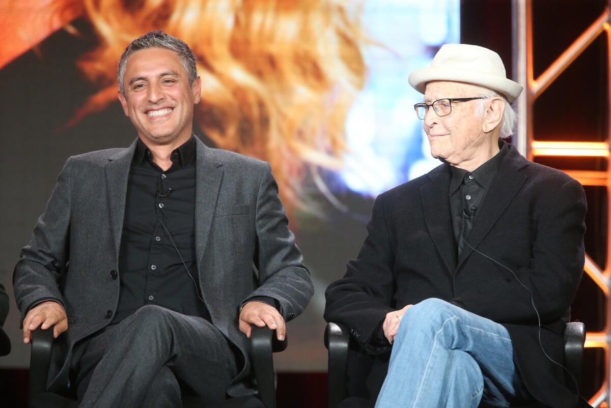 Reza Aslan, left, host of "Rough Draft," speaks during the 2016 TCA Press Tour with writer Norman Lear alongside.