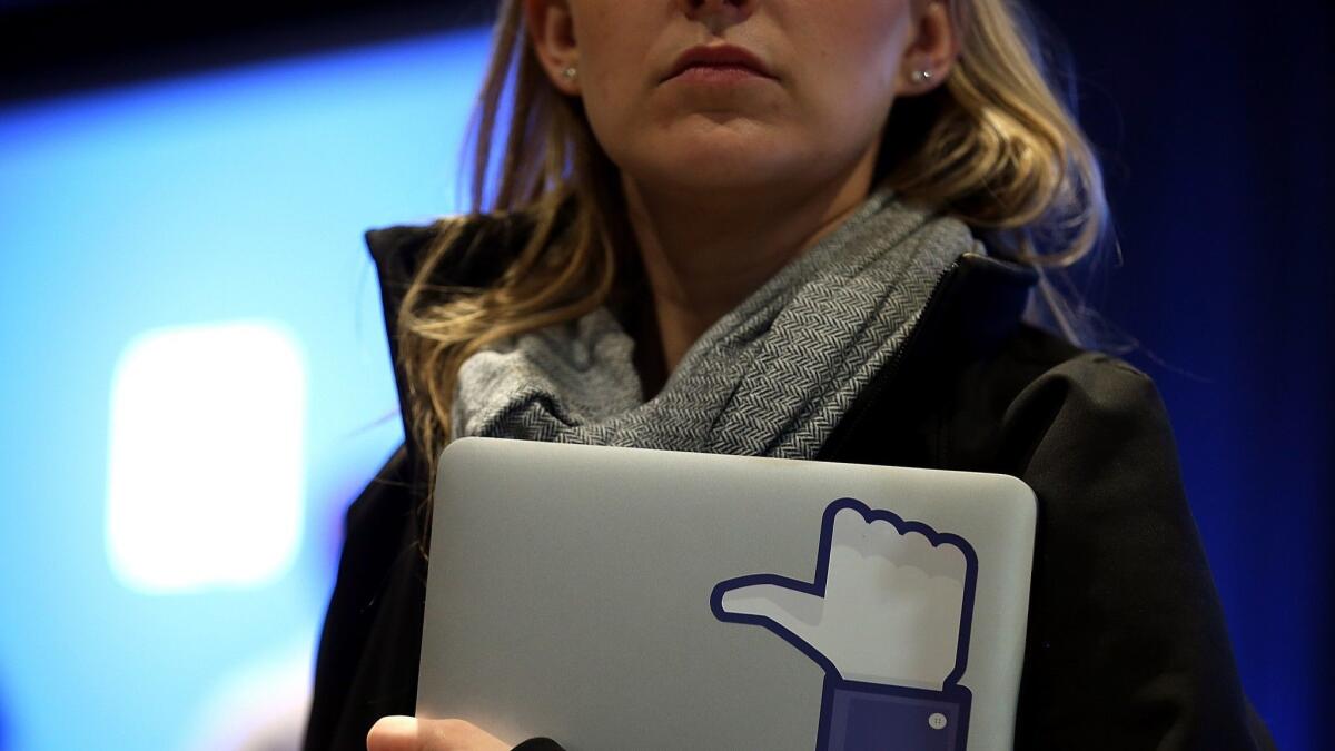 An employee at an event at Facebook headquarters in Menlo Park, Calif., in 2013. Facebook is among many large firms being urged by an activist investor to disclose statistics on their global gender pay gaps.