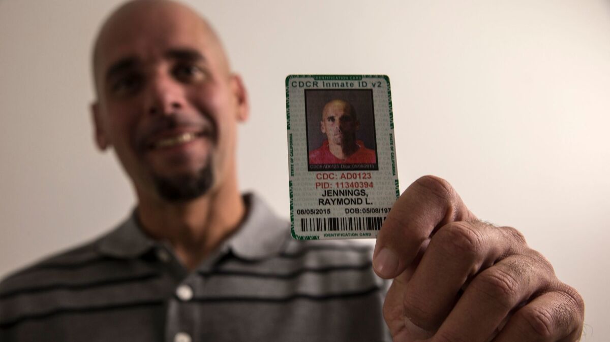 Raymond Lee Jennings holds his prison identification card. Now a free man, he spent 11 years behind bars for murder before the case against him unraveled in dramatic fashion. (Robert Gauthier / Los Angeles Times)