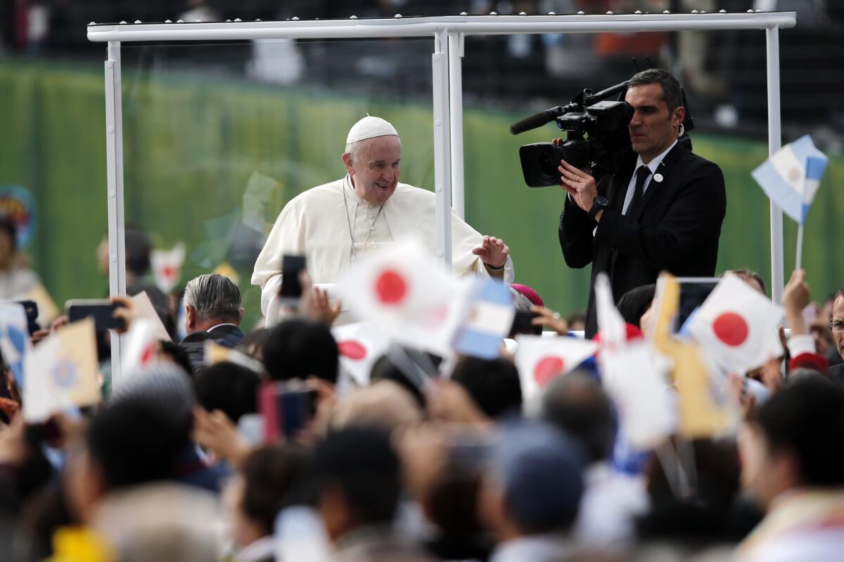 Pope Francis waves from his popemobile as he celebrates Mass in Nagasaki, Japan, on Sunday. 