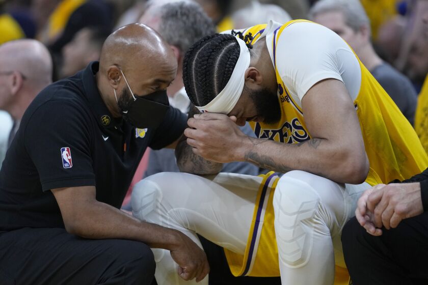 Los Angeles Lakers forward Anthony Davis sits on the bench after an injury during the second half of Game 5 of the team's NBA basketball second-round playoff series against the Golden State Warriors on Wednesday, May 10, 2023, in San Francisco. (AP Photo/Godofredo A. Vásquez)