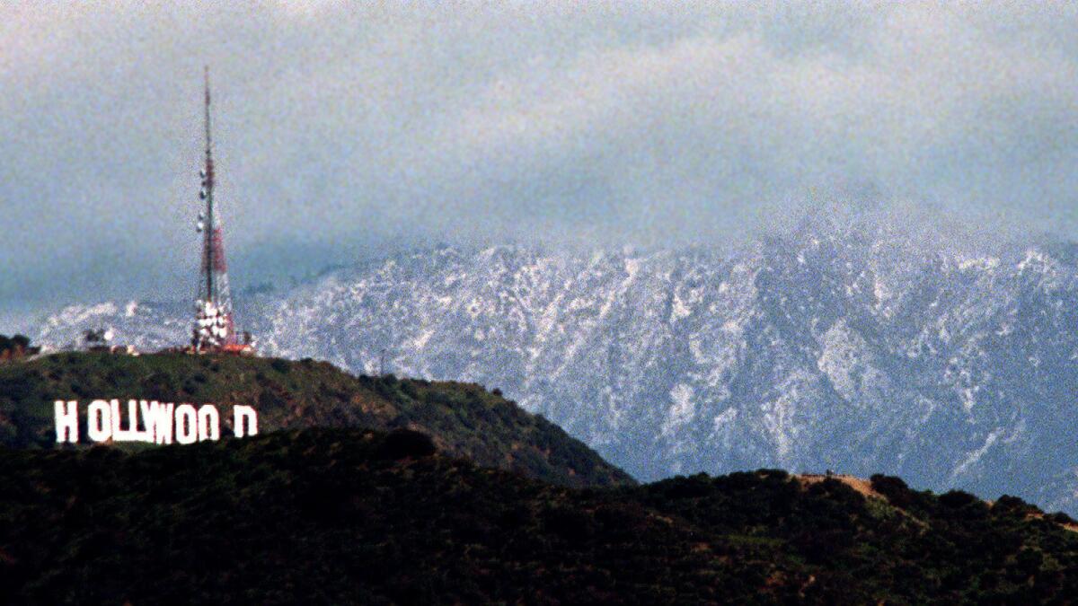 Snow forms a backdrop to the Hollywood sign after an El Niño storm in 1998.