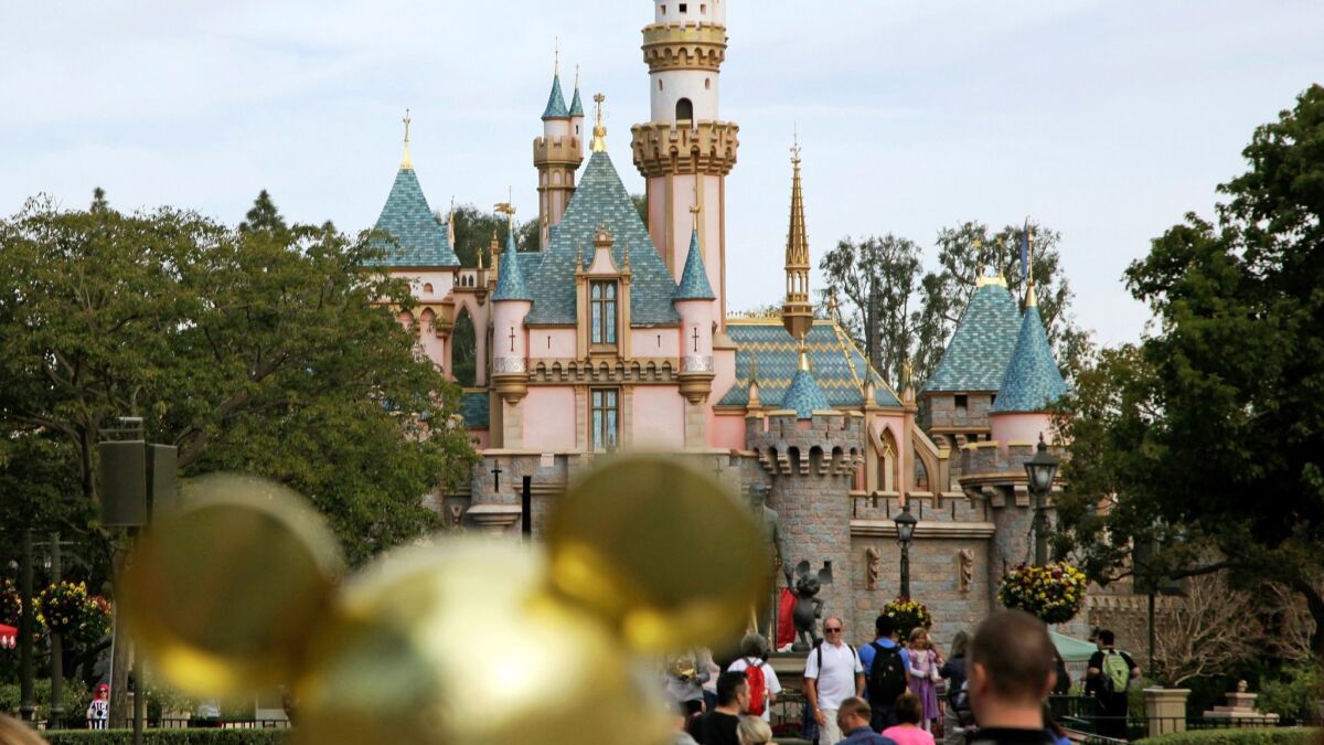 Visitors walk toward Sleeping Beauty's Castle at Disneyland in Anaheim.