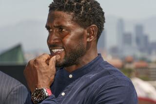 Former USC football player Reggie Bush listens to questions at a news conference announcing.