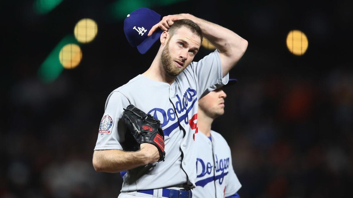 Dodgers reliever Tony Cingrani reacts after giving up a hit to the San Francisco Giants on April 27. Cingrani is scheduled to undergo arthroscopic surgery on his left shoulder.