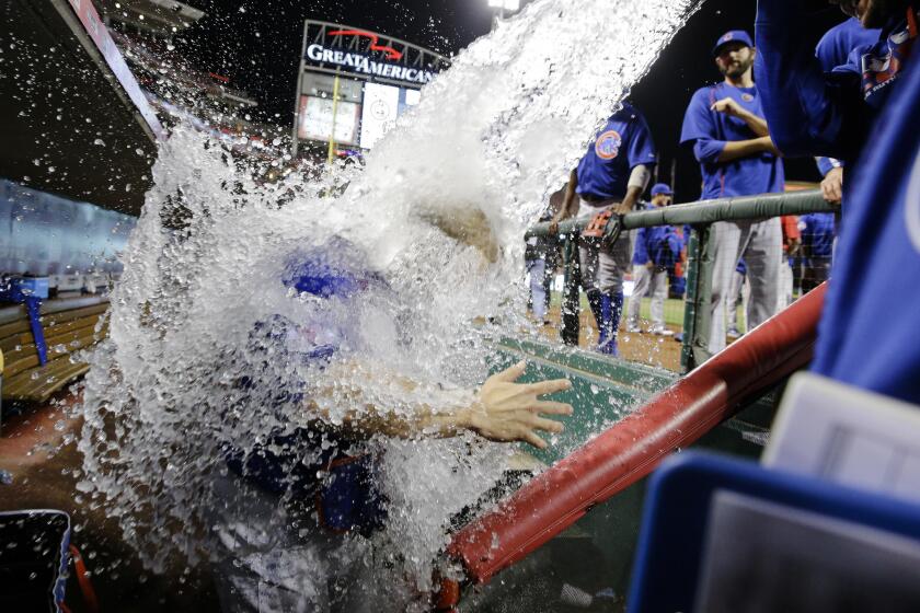 David Ross is doused in the dugout by his teammates after Jake Arrieta threw a no-hitter against the Reds on Thursday, April 21, 2016, in Cincinnati.