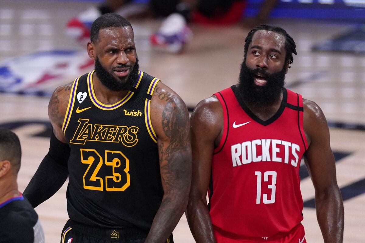 Lakers forward LeBron James and Houston Rockets forward James Harden react to a call.