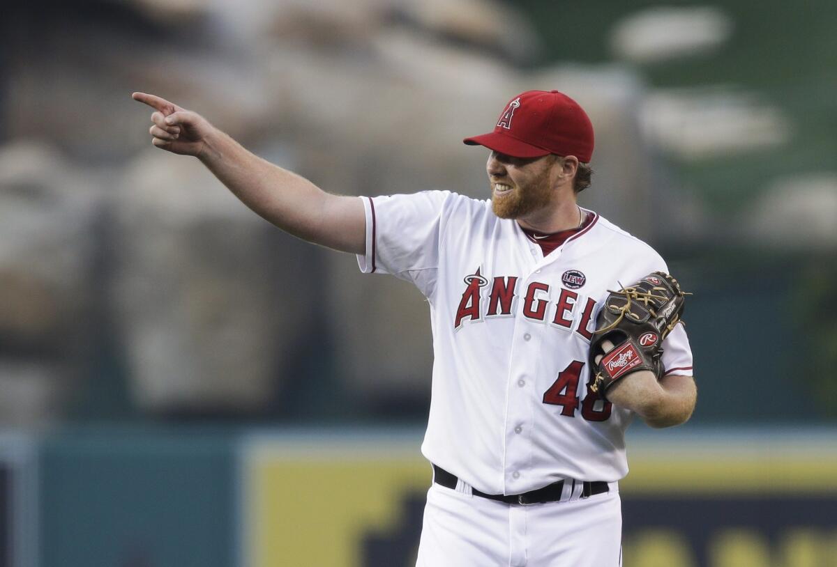 Angels pitcher Tommy Hanson points to a teammate during a game against Houston on May 31, 2013.