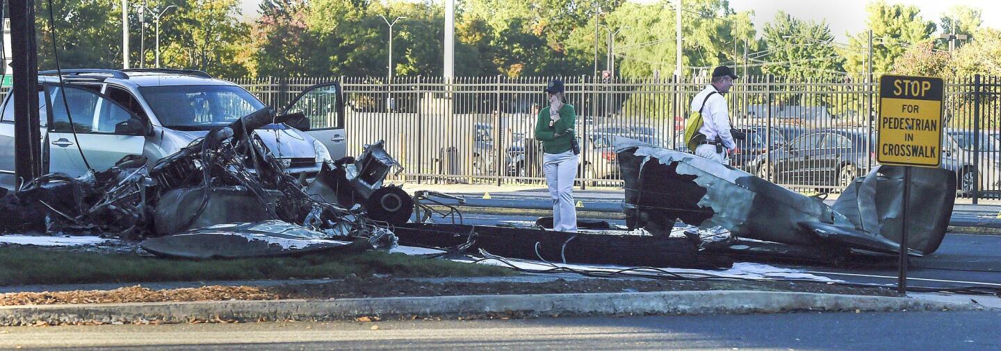 PLANE CRASH - A student pilot was killed and the pilot survived a plane crash on Main Street in East Hartford on Tuesday afternoon. Eyewitnesses say the plane nearly struck the mini van (at left).