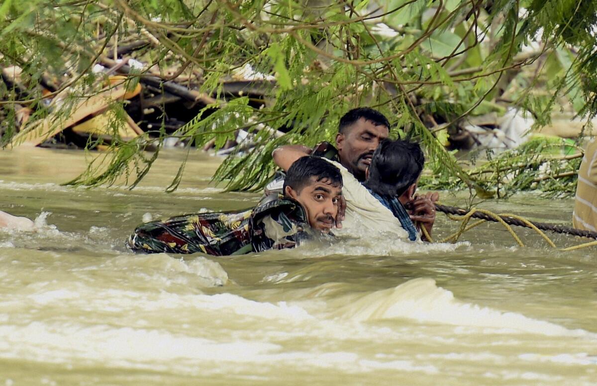 Indian soldiers rescue a man from floodwaters in Chennai on Dec. 3.