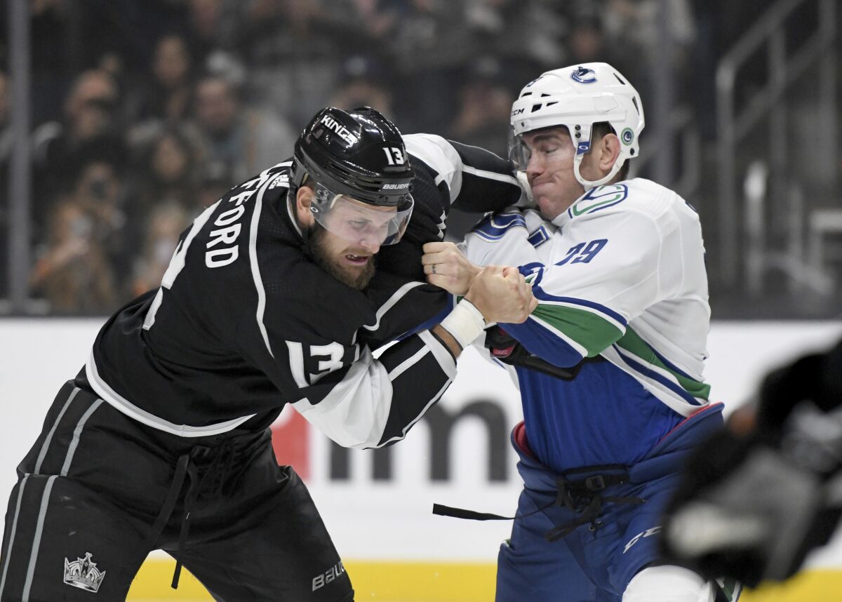 Kings left wing Kyle Clifford and Canucks left wing Micheal Ferland fight during a game at Staples Center.