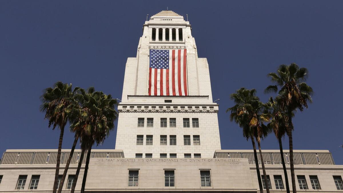 The American flag is draped on the south side of Los Angeles City Hall on Sept. 8, 2017.