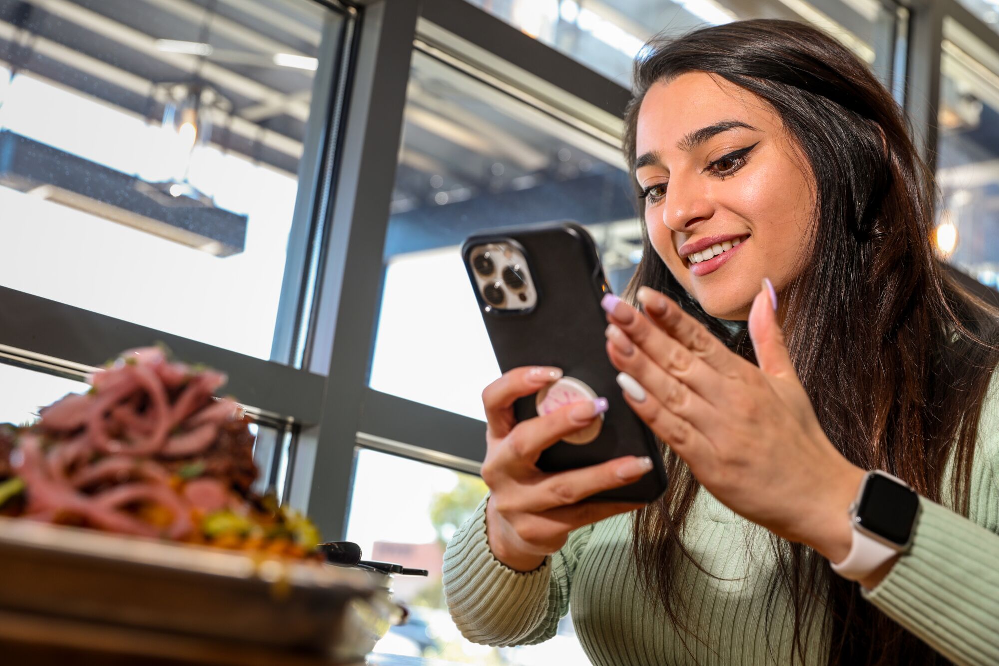 Ashley Rodriguez takes a picture of food