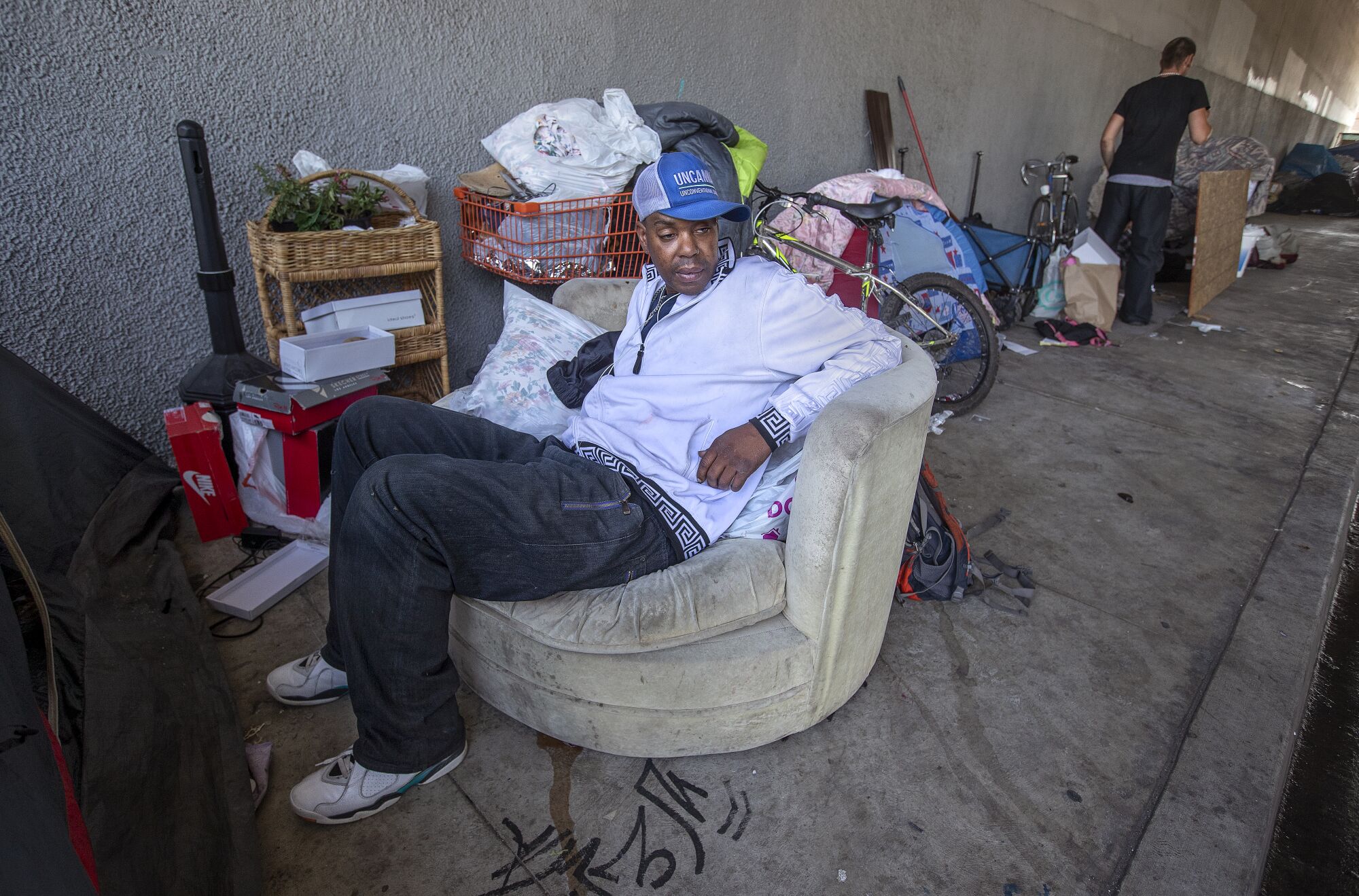 Chris Brown, who is homeless, visits friends at an encampment in Tarzana.