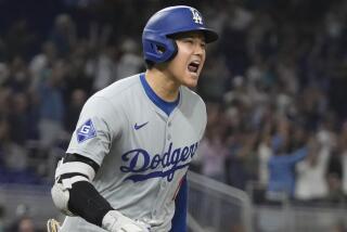 Shohei Ohtani yells while rounding the bases after hitting his 50th home run of the season 