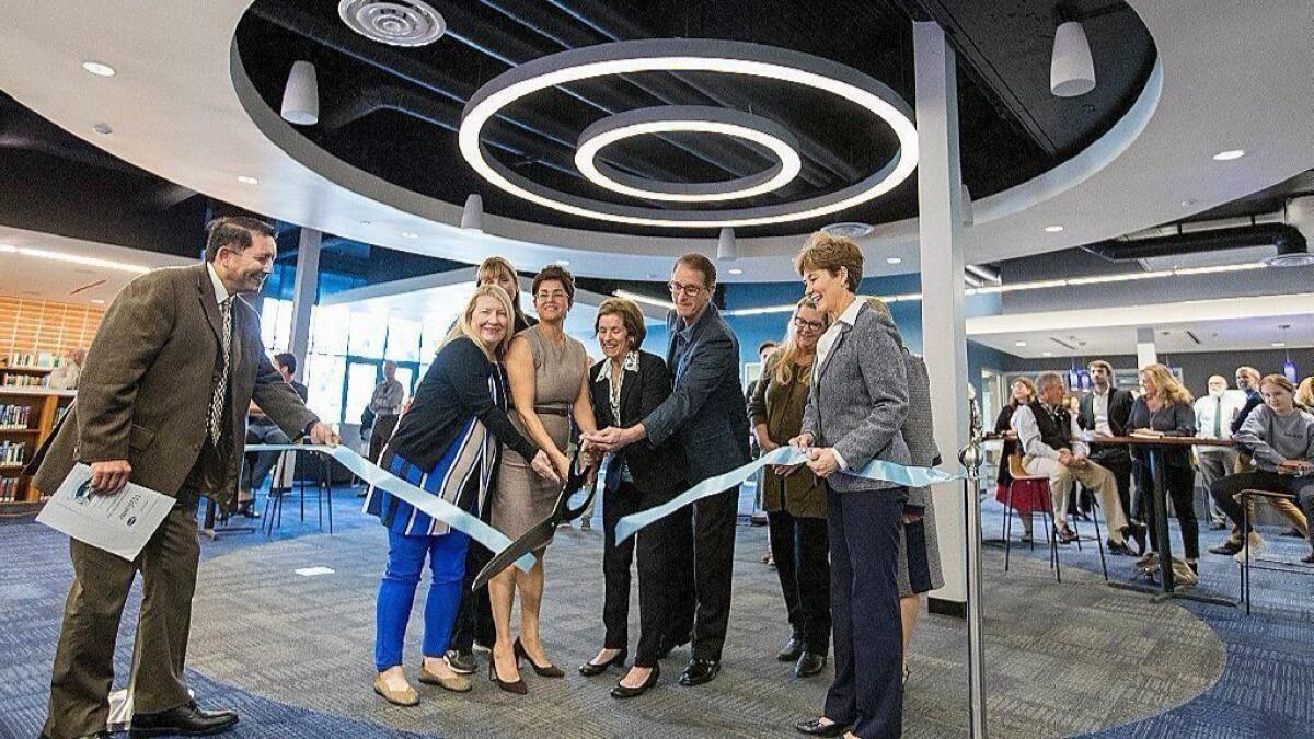 Officials cut a ribbon at Wednesday's opening ceremony for the Learning Resource Center at the Corona del Mar High and Middle School campus.